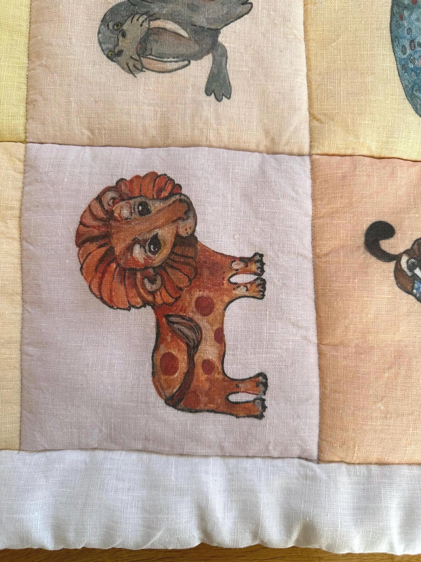 Quilted baby play mat with animal illustrations, handmade nursery floor mat"